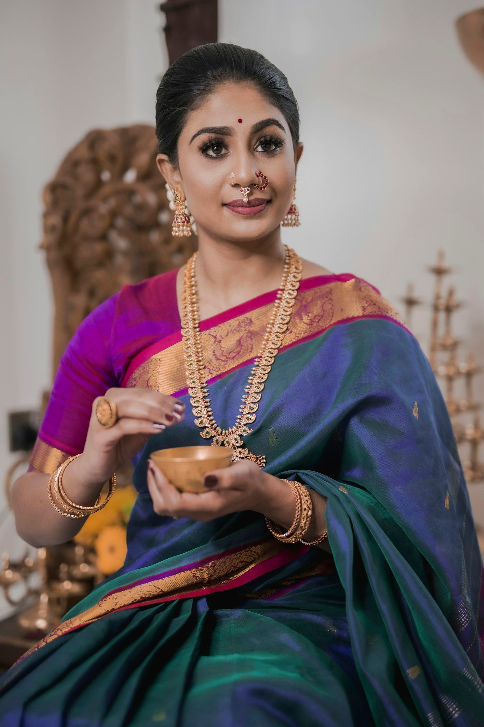 Woman draped in an elegant blue and gold silk saree