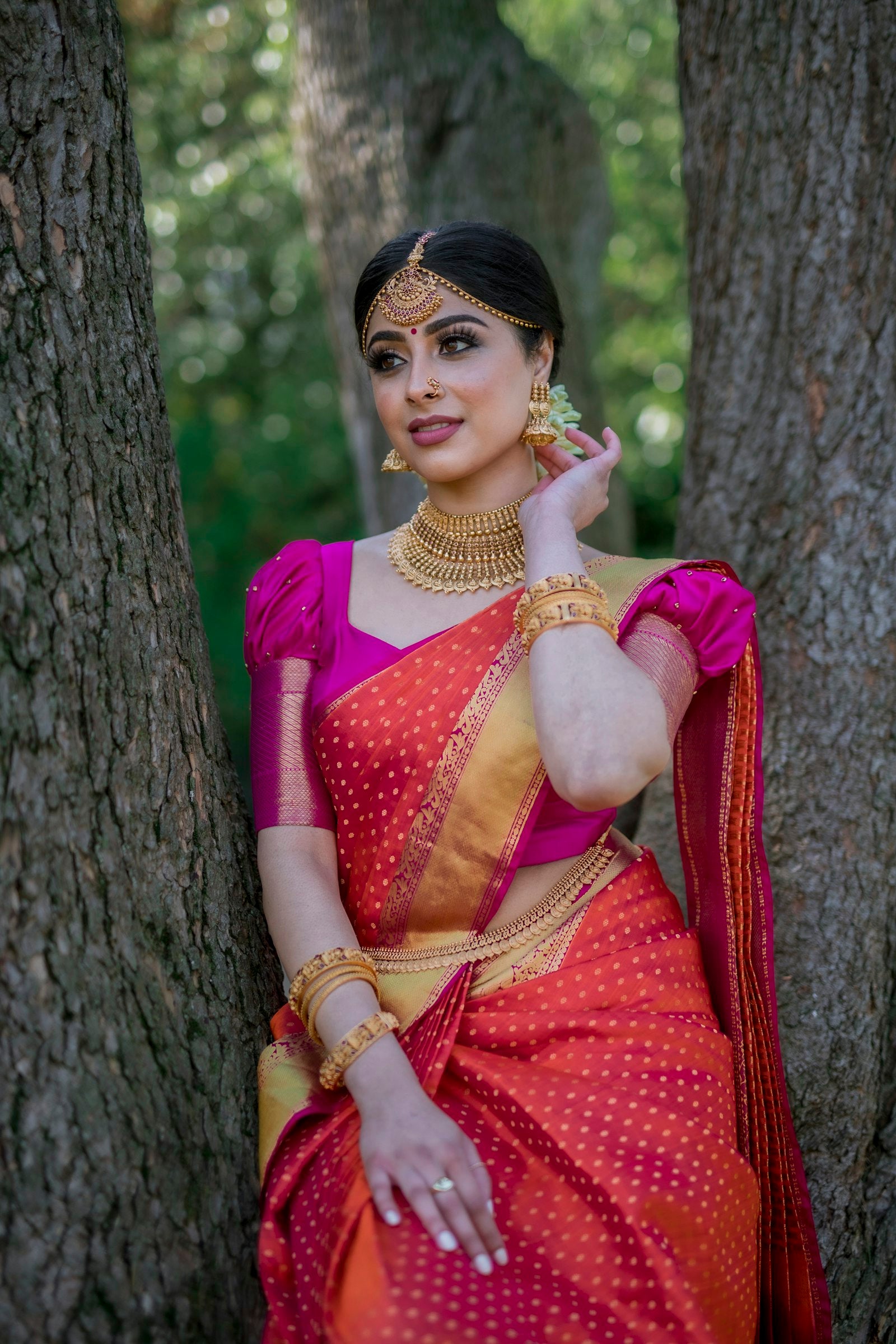 Woman draped in a traditional red and blue silk saree